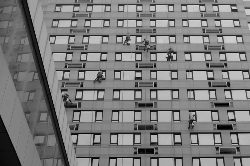 Window cleaners work on a tall building